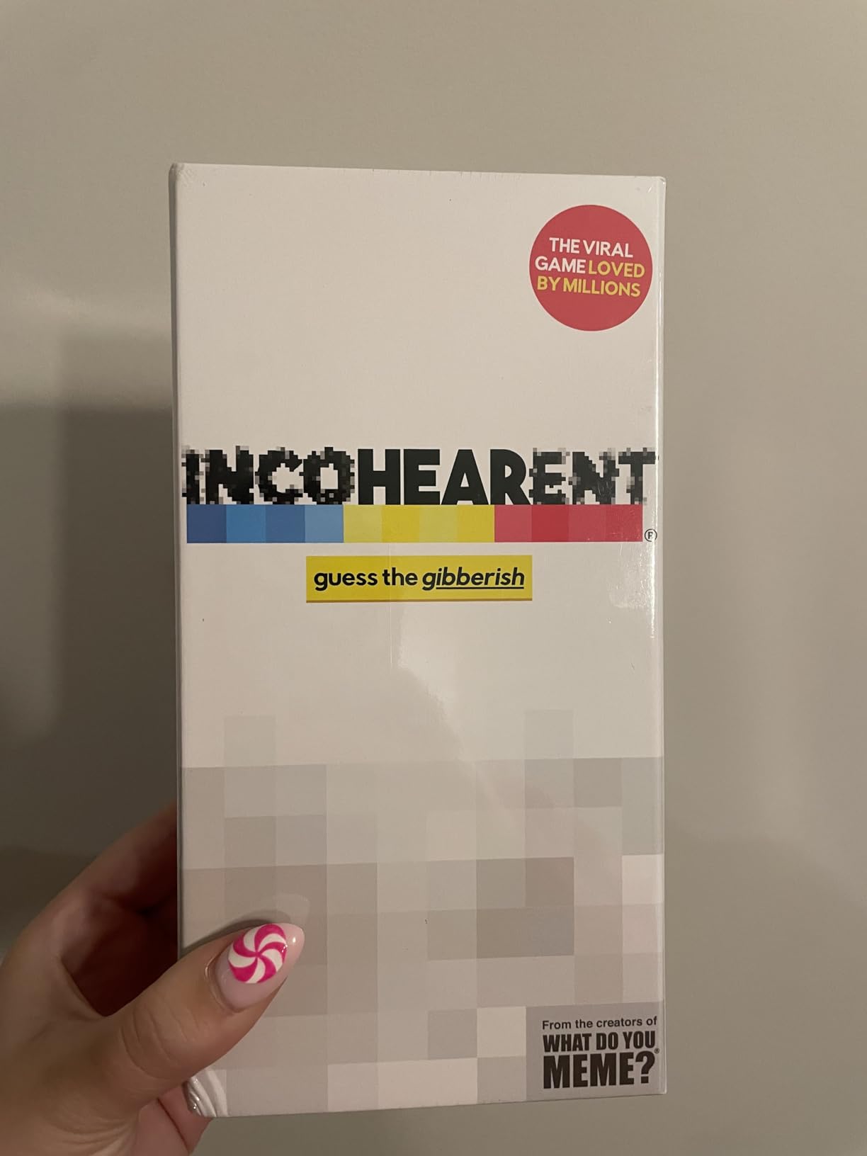 Customer holding the Incohearent guess the gibberish box