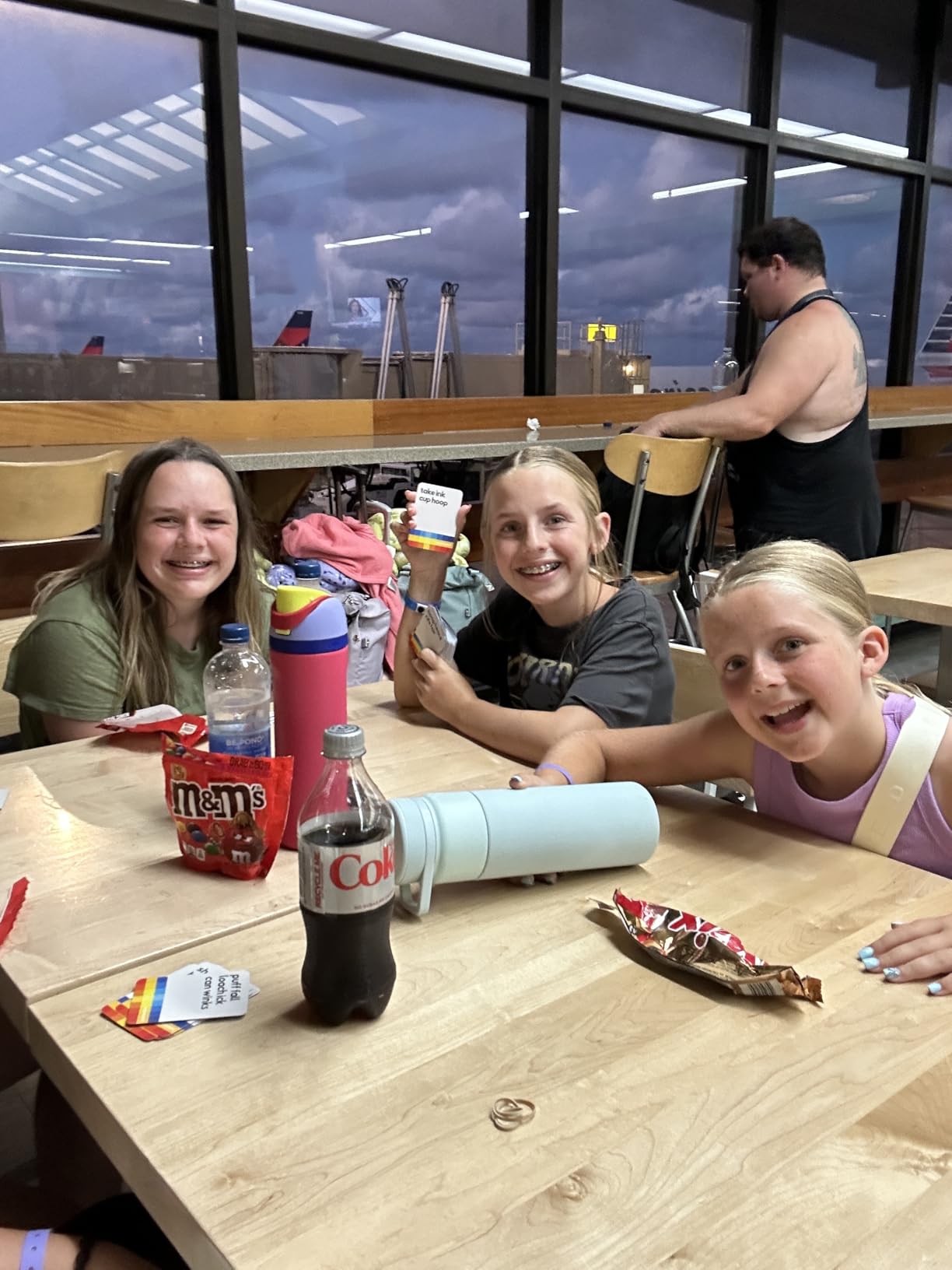 Kids smiling while playing Guess the Gibberish at a table